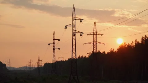 Sunset with a view of a power line running through a wooded area. Stock Footage 283083040