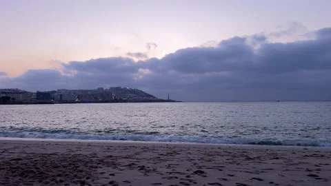 Sunset view on a quiet and relaxing beach and in the distance a city in north Stock Footage 204796704