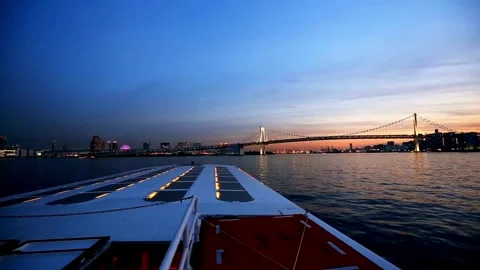 Sunset view of Rainbow Bridge from a moving boat 스톡 동영상 333816395