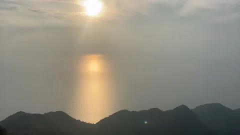 Sunset view with reflection beach from mountain top 4K video Stock Footage 238859412