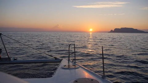 Sunset view from sailing catamaran boat traveling in Mediterranean Sicily, Italy Stock Footage 130135613
