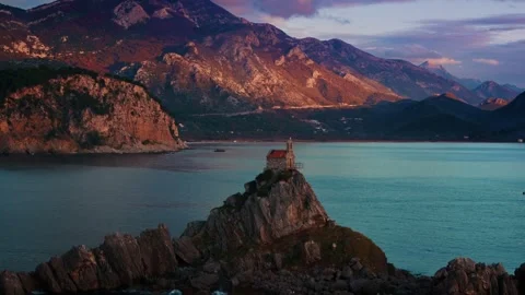Sunset view of saint stefan island church St. Nedjelja Church on a rocky outcrop Stock Footage 313733265