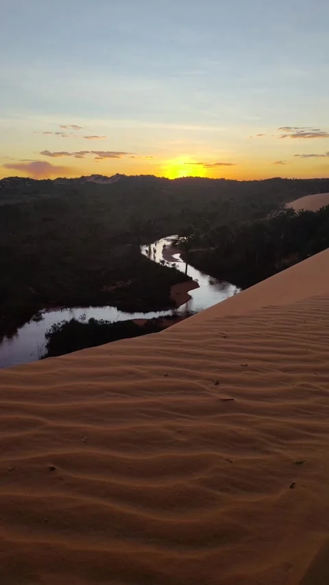 Sunset view from a sand at Jalapao Dune over a river and forest landscape. 스톡 동영상 312898154