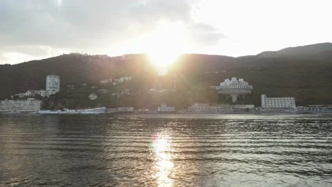 Sunset. view from the sea to the coastline. mountainous area with hotels near Stock Footage 167930367