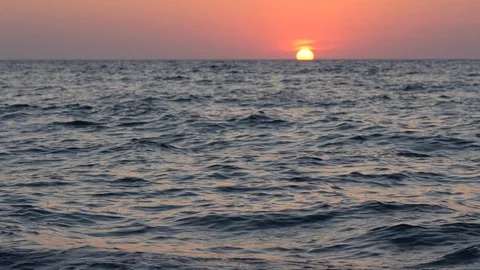 Sunset view seaside sea with waves in Crete Greece sun falling into the sea Stock Footage 97851546