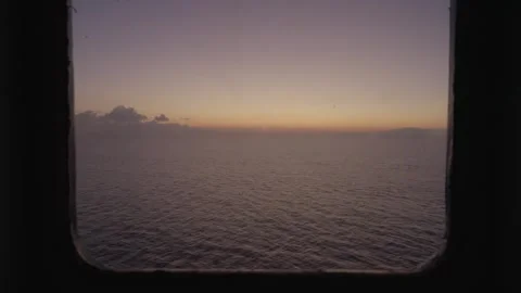 Sunset view from the ship's window, zoom in. Sea voyage Stock Footage 294743607