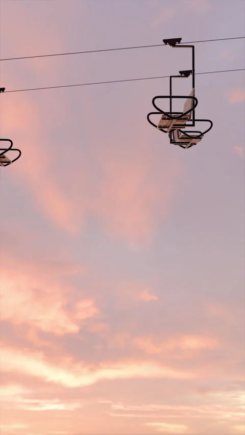 Sunset View of Skilift Looping Through Serene Skies With Soft Vibrant Colors Stock Footage 315468240