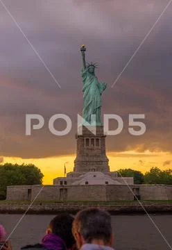 Sunset View of Statue of Liberty in New York Harbor Stock Photos