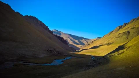 Sunset view to Tash-Rabat river and valley in Naryn province, Kyrgyzstan Stock Photos