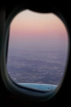 Sunset view through airplane take off window in Porto Stock Photos