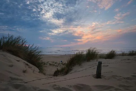 Sunset view through dune path toward the North Sea Stock Photos