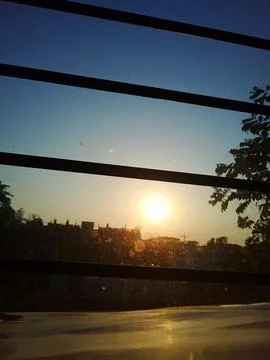 Sunset View Through Window with Bars Stock Photos