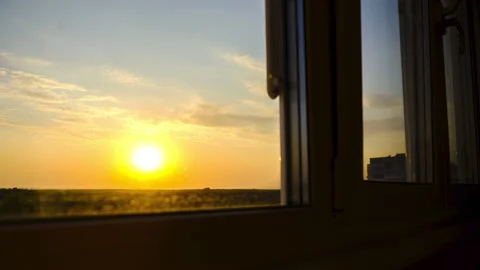 Sunset view through the Window. Bright Yellow Sun Moves over Horizon. Time Lapse Stock Footage 140510647