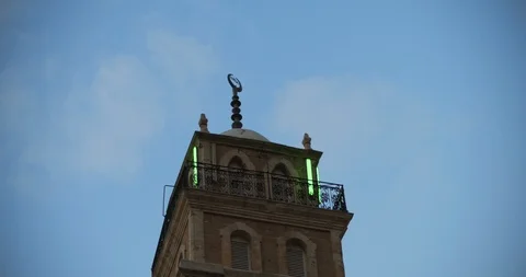 Sunset view, top of the muslim mosque minaret with blue sky in the background Stock Footage 123665141
