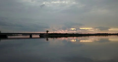 Sunset view from the top of the river with a bridge Stock Footage 98650294