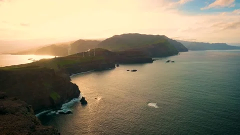 Sunset view of wind turbines for energy production at the ocean coast of Madeira Stock Footage 160102532