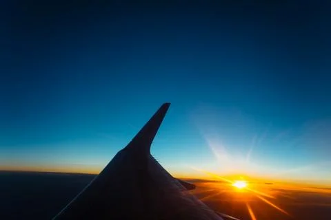 Sunset view from the window of an airplane Stock Photos