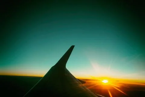 Sunset view from the window of an airplane. Stock Photos
