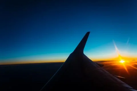 Sunset view from the window of an airplane Stock Photos