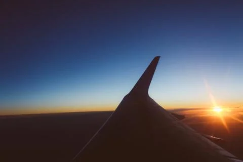 Sunset view from the window of an airplane Stock Photos