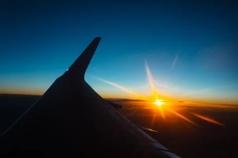 Sunset view from the window of an airplane Stock Photos