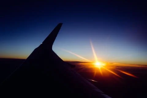 Sunset view from the window of an airplane Stock Photos