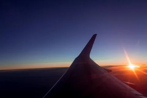Sunset view from the window of an airplane Stock Photos