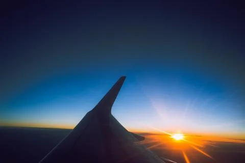 Sunset view from the window of an airplane Stock Photos