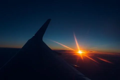 Sunset view from the window of an airplane Stock Photos