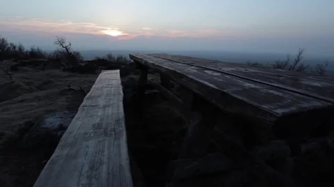 Sunset viewed from a bench Stock Footage 76757673