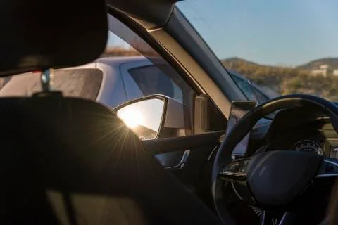 Sunset viewed from inside a Car interior in the mirror sun. Stock Photos