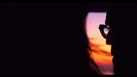 Sunset views from airplane window showcasing travelers in reflective moments Stock-Footage 312700145