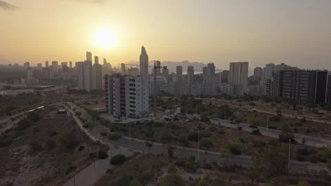 Sunset views over a city skyline with buildings and roads shown from differ.. Stock Footage 340192589