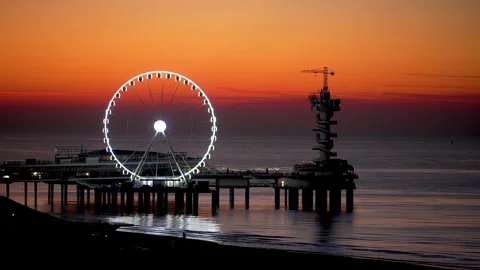Sunset Views of the Pier and Ferris Wheel at Scheveningen Seaside Resort Stock Footage 300856917