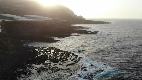 Sunset in volcanic lava formation with waves on wild beach and field of banana t 動画素材 136246925