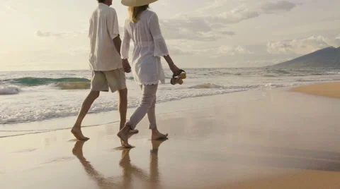Sunset Walk on a Luxury Beach. Happy Retired Couple on Tropical Vacation. Stock Footage 57714202