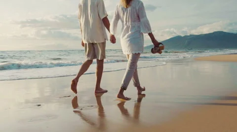 Sunset Walk on a Luxury Beach. Happy Retired Couple on Tropical Vacation. Stock-Footage 57714766