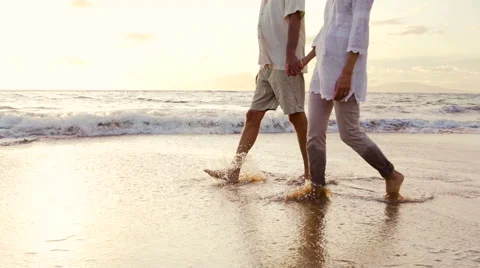 Sunset Walk on a Luxury Beach. Happy Retired Couple on Tropical Vacation. Stock Footage