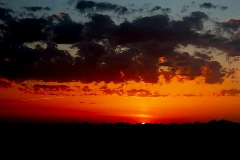 Sunset on a warm summer evening. red orange sky before sunset . Stock Photos