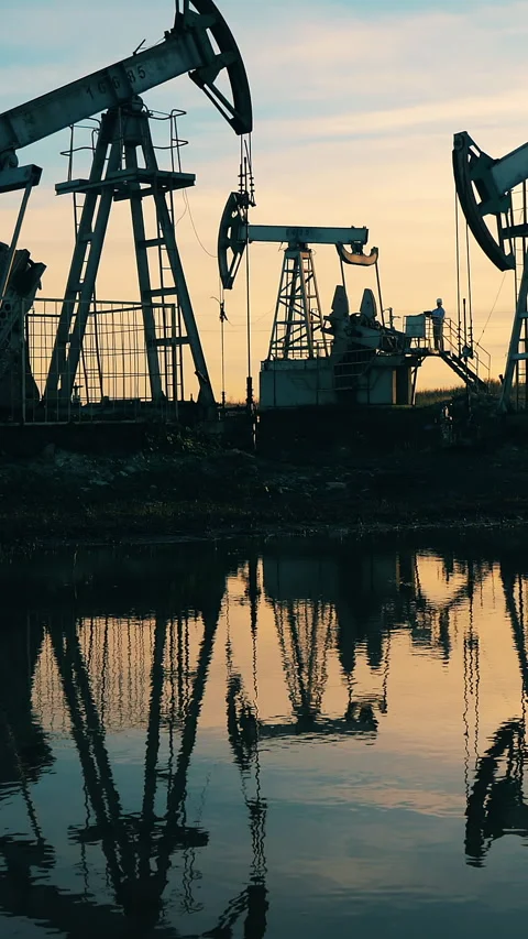 Sunset waterscape with an oil extraction site. Oil industry concept. Stock Footage 269524149