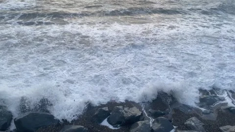 Sunset Wave Crashing on Rocks From Above - 4K Stock Footage 332781193