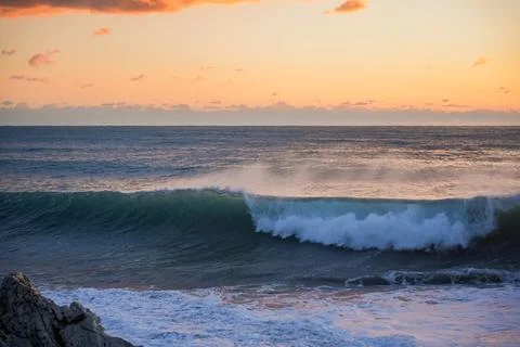 Sunset Wave Curling Over Winter Sea Stock Photos
