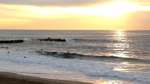 Sunset Waves and Surfers Stock Footage 82849899