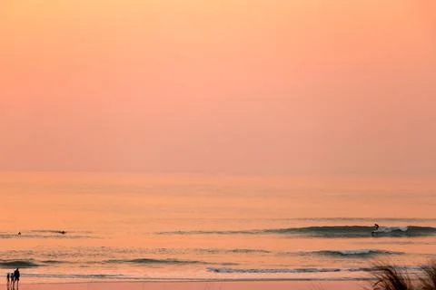 Sunset waves break in the Pacific Ocean on a California beach Stock Photos