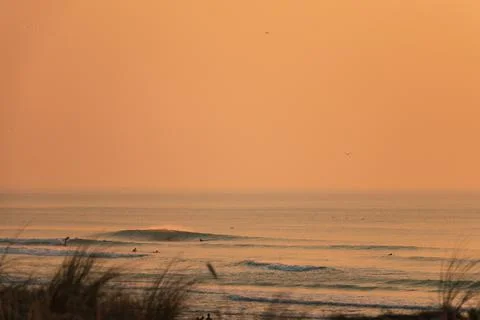 Sunset waves break in the Pacific Ocean on a California beach Stock Photos