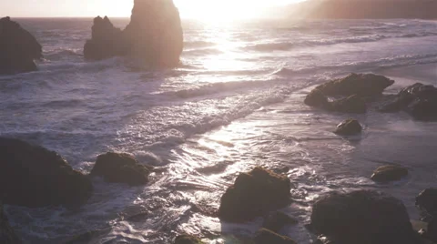 Sunset waves crash against rocks 4k Video stock 39735546