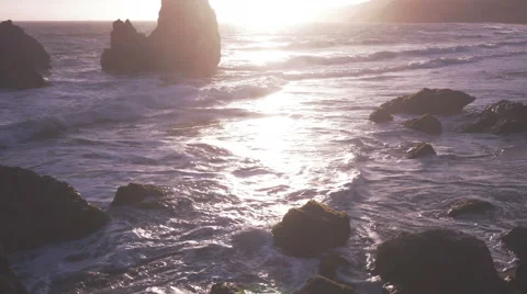 Sunset waves crash against rocks Video stock 41927787