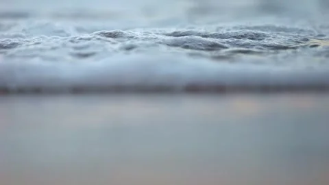 Sunset waves filmed in slow motion with a telephoto lens showing compressed.. Stock Footage 313613311