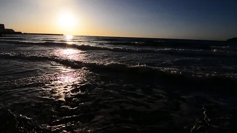 Sunset waves roll onto shore, medium Stock Footage 73811204