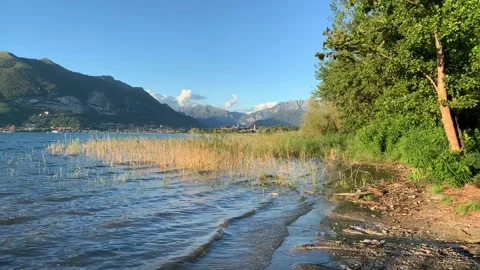 Sunset, waves on the shore of an alpine lake Stock Footage 138399417